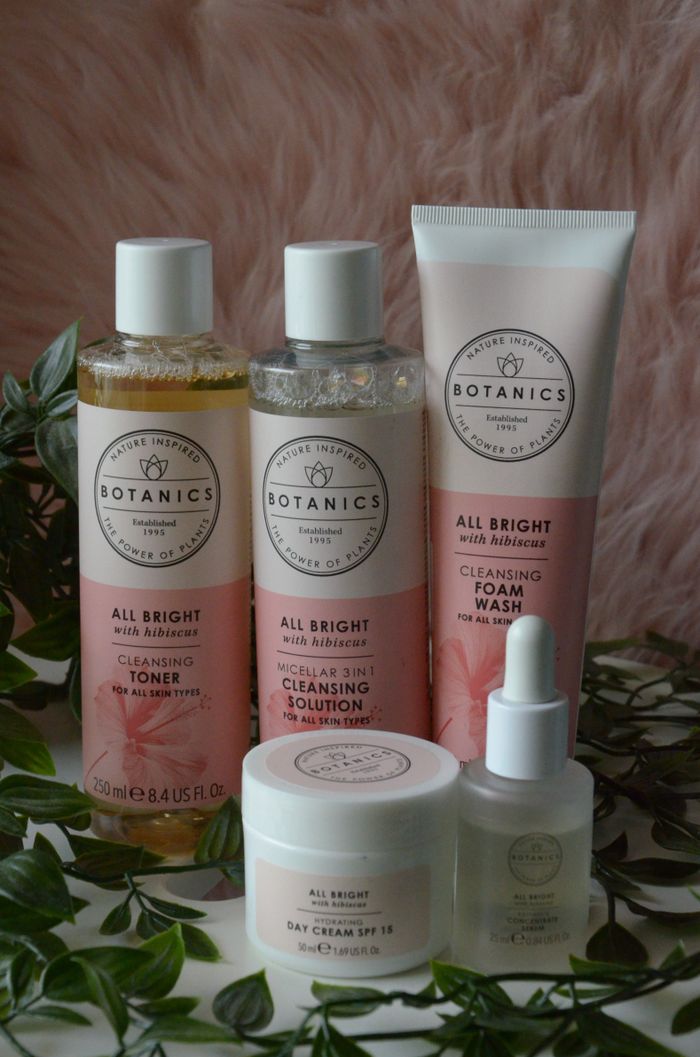 A collection of skincare products featuring botanical ingredients and presented with natural elements.